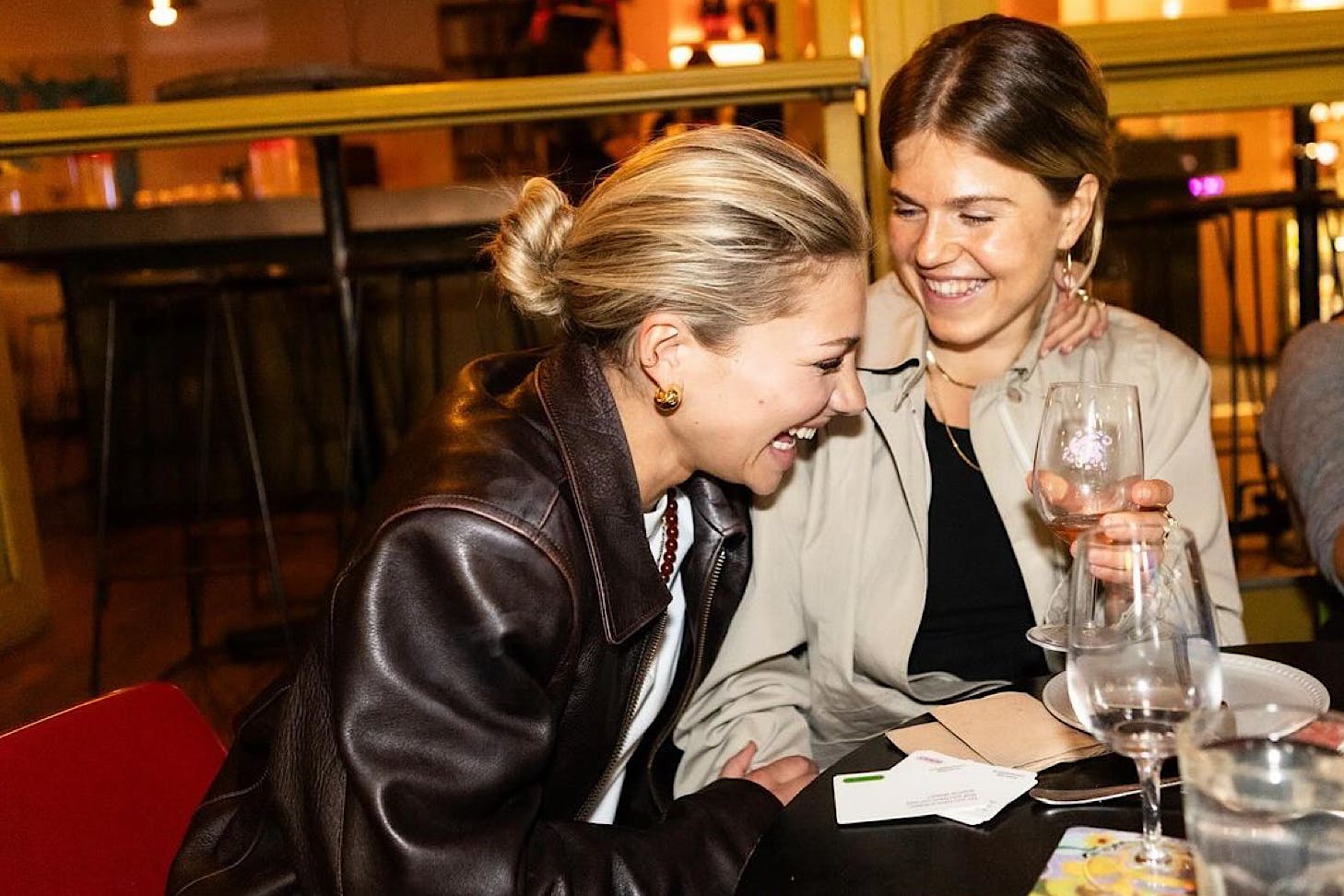Two women laugh together.